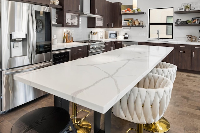 kitchen with exhaust hood, wine cooler, a kitchen bar, dark brown cabinetry, and stainless steel appliances