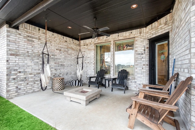 view of patio / terrace with entry steps, an outdoor fire pit, and ceiling fan