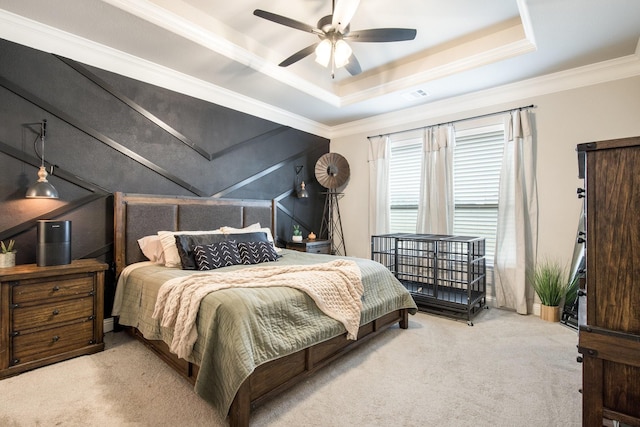 carpeted bedroom featuring visible vents, a raised ceiling, ceiling fan, and crown molding