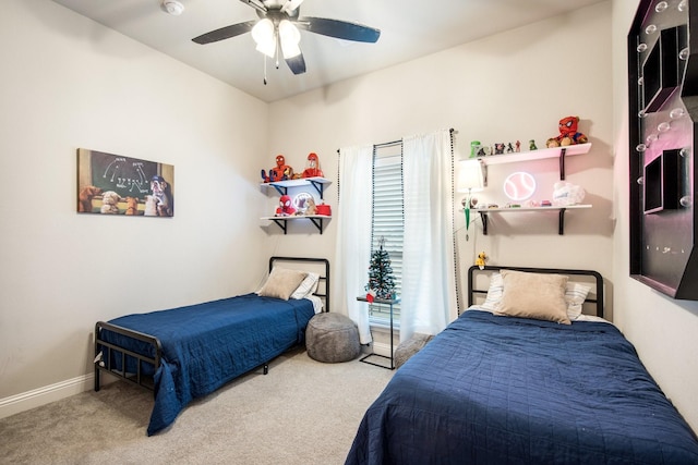 carpeted bedroom featuring baseboards and a ceiling fan