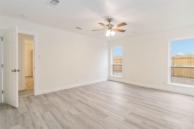 spare room featuring ceiling fan and light hardwood / wood-style flooring