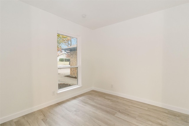 empty room with light hardwood / wood-style flooring