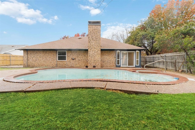 view of pool with a lawn