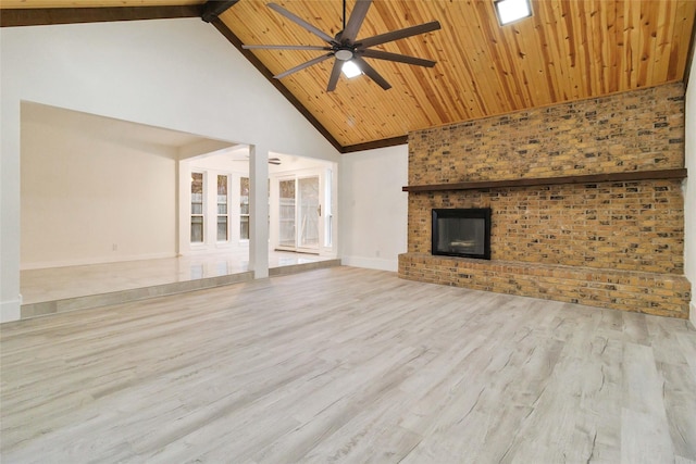 unfurnished living room featuring wooden ceiling, ceiling fan, light hardwood / wood-style flooring, a brick fireplace, and high vaulted ceiling