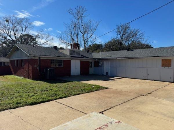 ranch-style home featuring a garage and a front yard