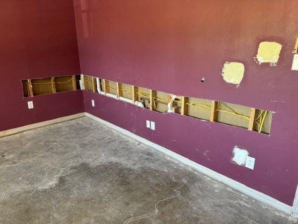 unfurnished room featuring concrete flooring