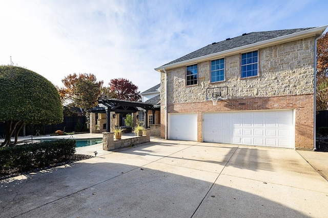 view of front of house with a pergola and a garage