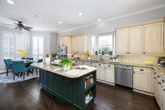 kitchen with sink, dark wood-type flooring, tasteful backsplash, light stone counters, and appliances with stainless steel finishes