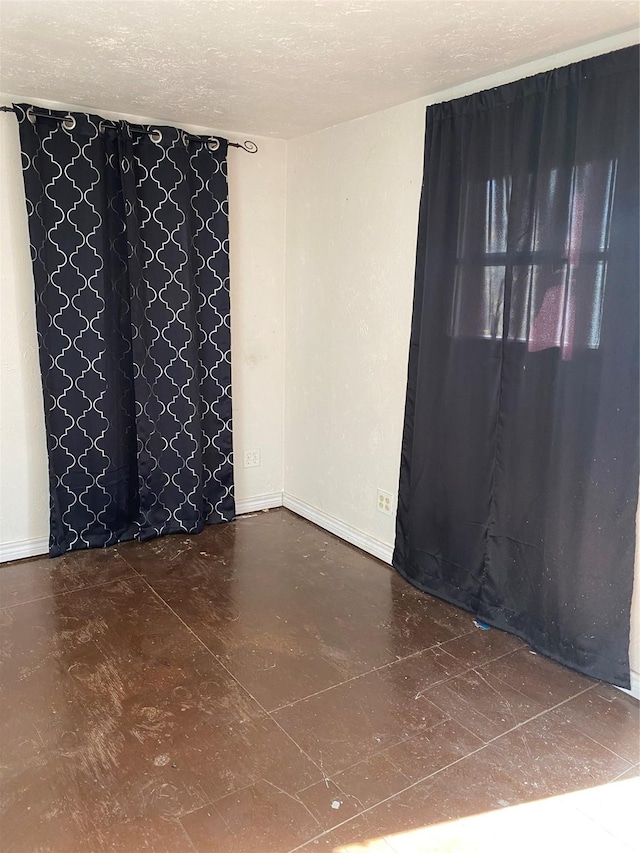 empty room featuring a textured ceiling