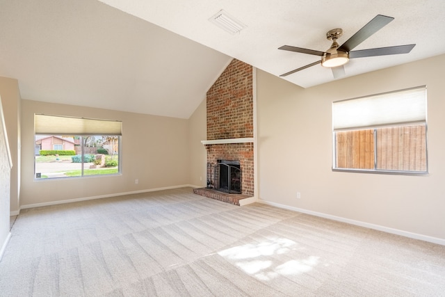 unfurnished living room with a fireplace, light colored carpet, vaulted ceiling, and ceiling fan