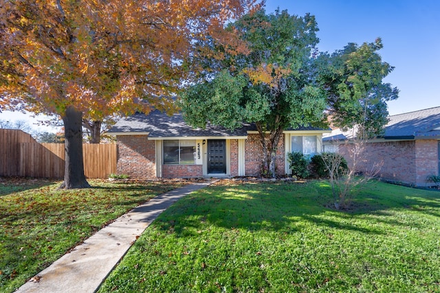 ranch-style home with a front lawn