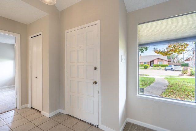 entryway with light tile patterned floors