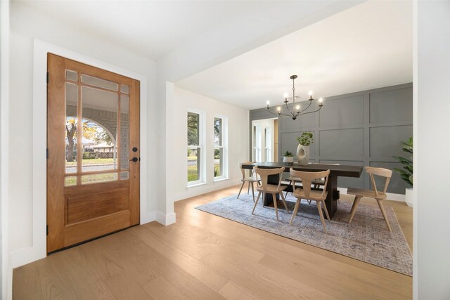 dining area featuring a chandelier, light hardwood / wood-style flooring, and a healthy amount of sunlight