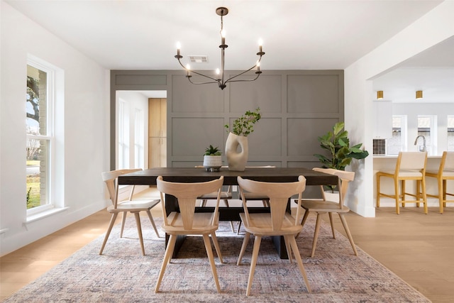 dining area featuring a chandelier and light wood-type flooring