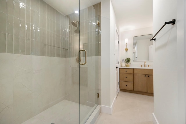 bathroom with tile patterned floors, vanity, and a shower with shower door