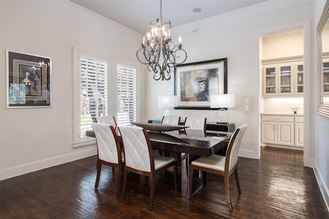 dining room featuring dark hardwood / wood-style flooring, an inviting chandelier, and crown molding