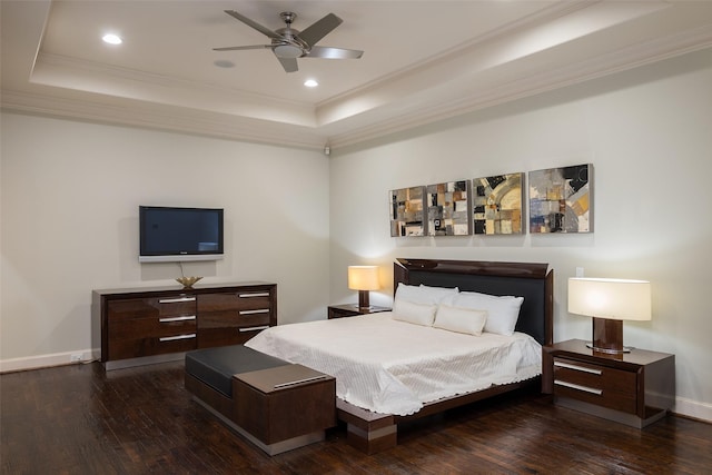 bedroom with a raised ceiling, ceiling fan, dark hardwood / wood-style flooring, and ornamental molding