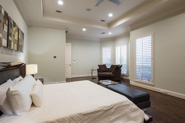 bedroom featuring a tray ceiling, ceiling fan, crown molding, and dark wood-type flooring