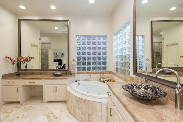 bathroom featuring vanity, ornamental molding, and independent shower and bath