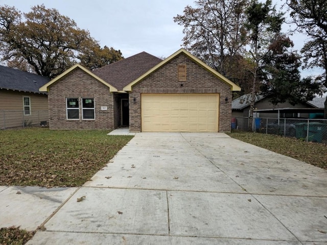 view of front of house featuring a garage and a front lawn