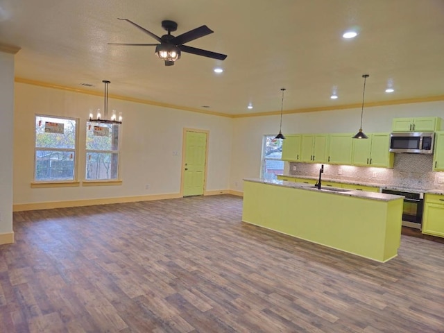 kitchen with stainless steel appliances, hanging light fixtures, a healthy amount of sunlight, and dark hardwood / wood-style floors