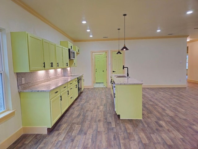 kitchen with pendant lighting, sink, dark wood-type flooring, and light stone countertops