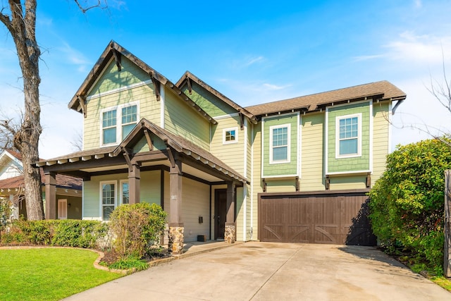 view of front of house featuring a garage and a front yard