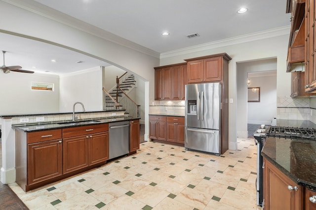 kitchen with decorative backsplash, sink, ornamental molding, and stainless steel appliances