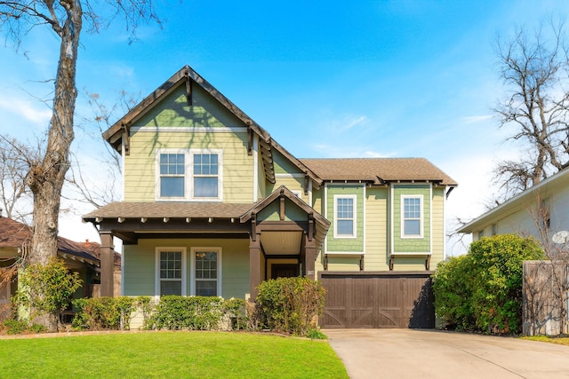 view of front of property with a garage, a porch, and a front yard