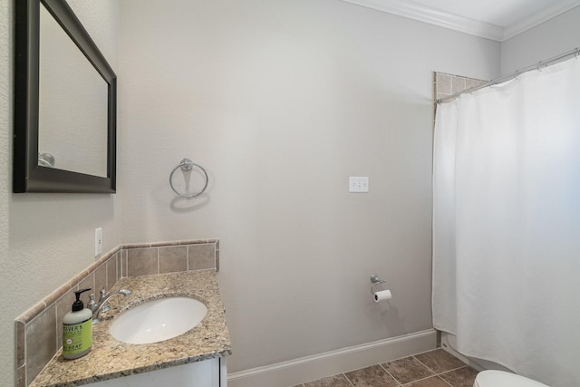 bathroom with tile patterned floors, toilet, vanity, and ornamental molding