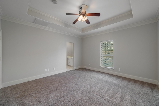 empty room with ceiling fan, ornamental molding, light carpet, and a tray ceiling