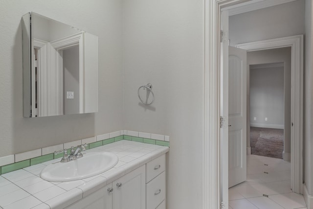 bathroom with tile patterned floors and vanity