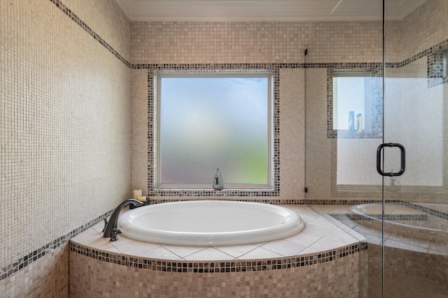 bathroom featuring shower with separate bathtub