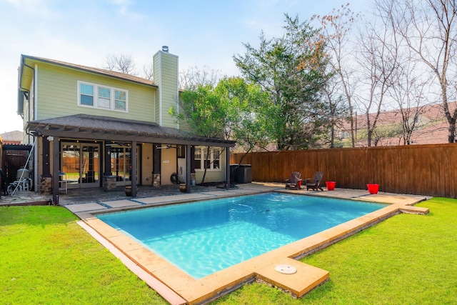 view of swimming pool featuring a yard and a patio area