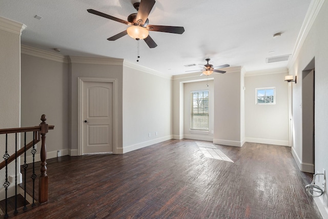 spare room featuring ornamental molding and dark wood-type flooring