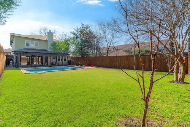 view of yard featuring a patio area and a fenced in pool