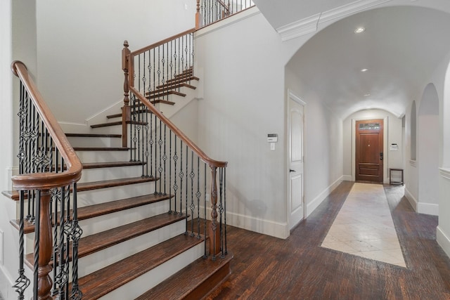 foyer with dark hardwood / wood-style floors and ornamental molding