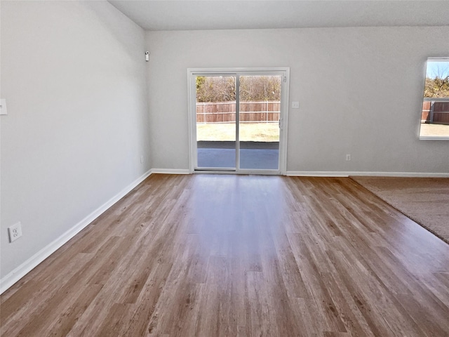 empty room featuring light wood-type flooring and a healthy amount of sunlight