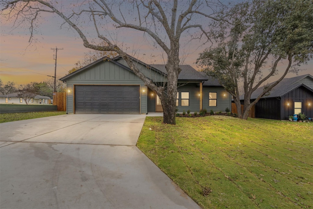 view of front facade with a lawn and a garage