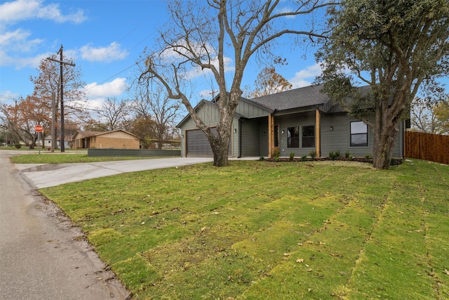 ranch-style home with a garage and a front lawn