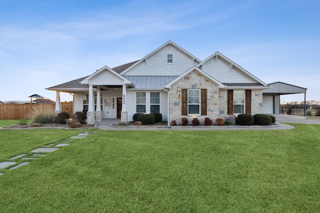 craftsman-style house featuring covered porch, a front lawn, and a garage