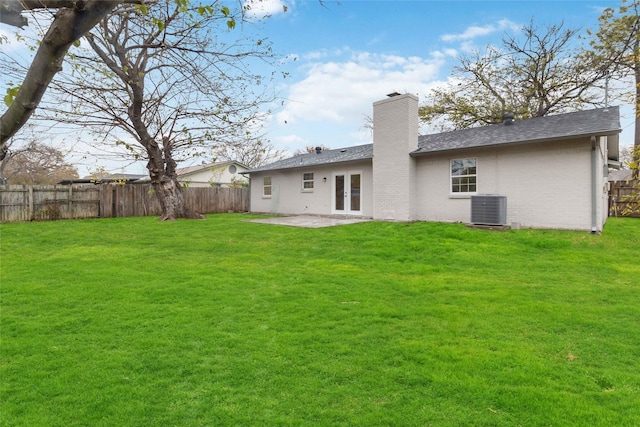 back of house with french doors, a yard, central AC unit, and a patio