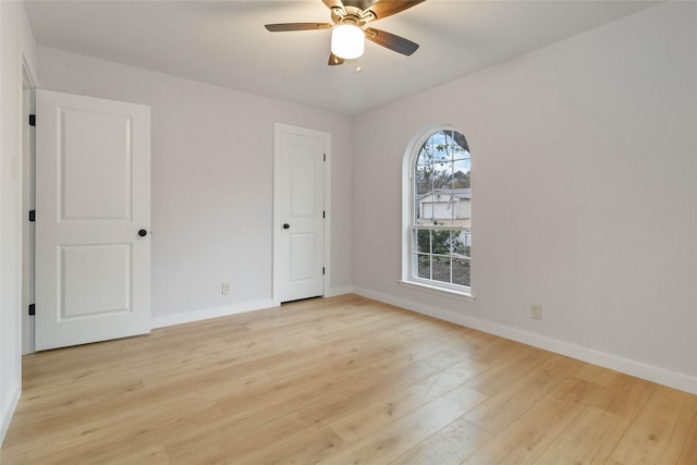 spare room with light wood-type flooring and ceiling fan