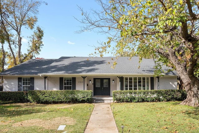 single story home featuring french doors and a front yard