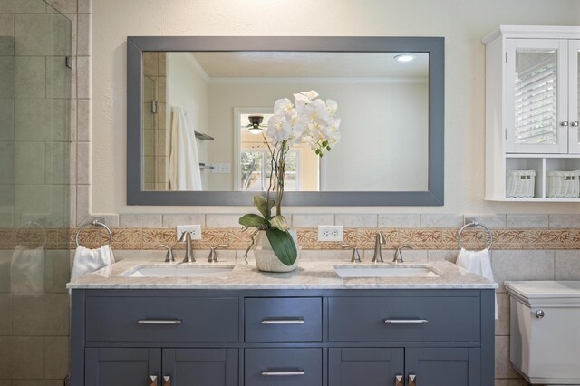 bathroom with crown molding, vanity, and toilet