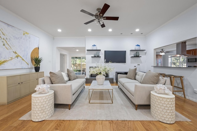 living room with ceiling fan, light hardwood / wood-style flooring, and ornamental molding