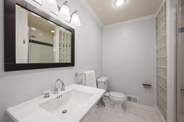 bathroom with toilet, a shower with shower door, crown molding, and sink