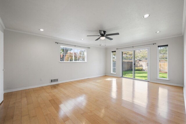 unfurnished room with ceiling fan, light wood-type flooring, and ornamental molding