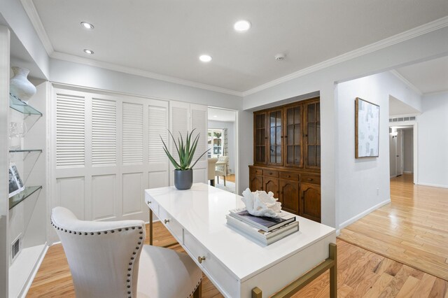 office space featuring light hardwood / wood-style floors and crown molding