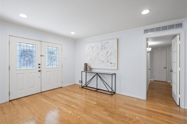 foyer featuring light hardwood / wood-style floors and ornamental molding